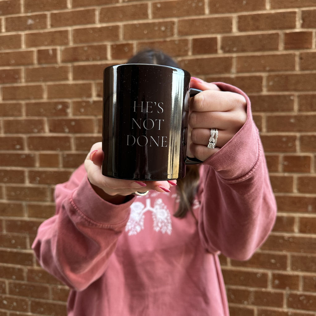 He's Not Done Mug